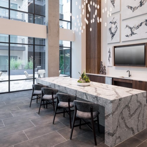 a large room with a table and chairs and a sink